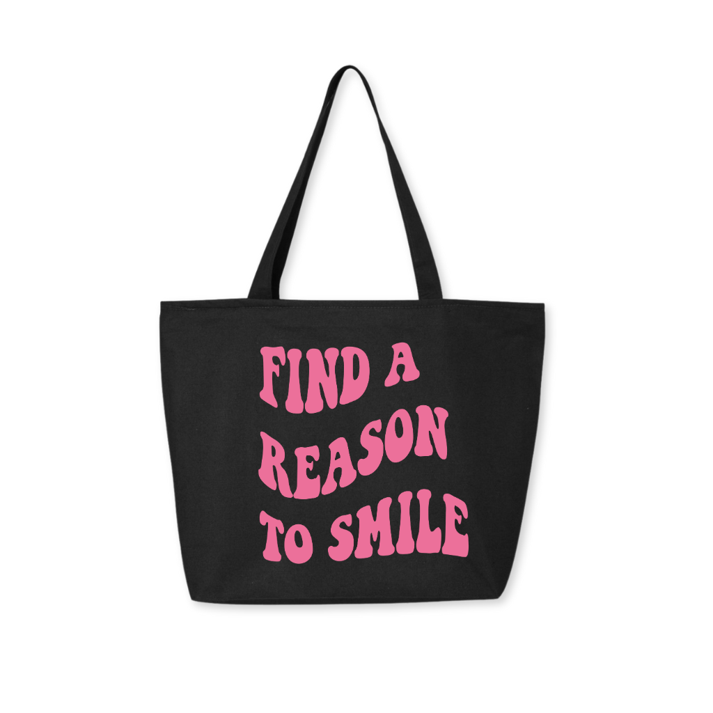 Black tote bag with pink groovy-style 'Find A Reason To Smile' design, fun and inspiring carry bag with a pop of color
