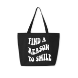Black tote bag with white groovy font 'Find A Reason To Smile' message, retro-style carryall with modern purpose